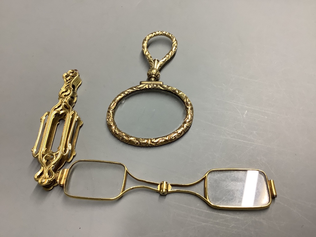 A late 19th century French yellow metal (18ct poincon mark) lorgnette and a yellow metal overlaid eye glass.